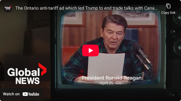 Screenshot of a YouTube video which shows Ronald Reagan wearing a plaid shirt and reading from a paper into two microphones